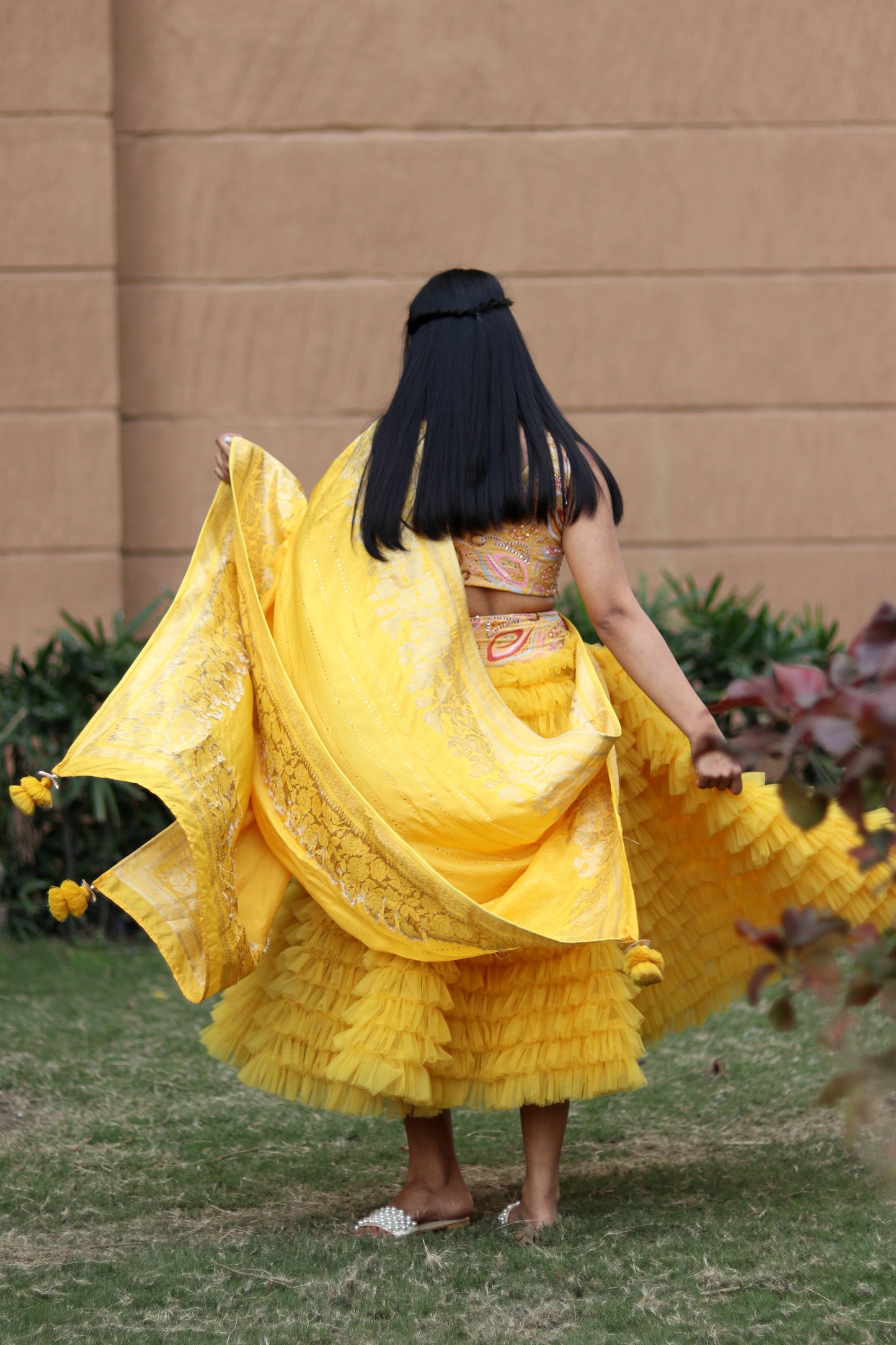 Mahi Bakshi in Modo Caldo yellow ruffled tulle lehenga and hand embellished crop top for festive wear