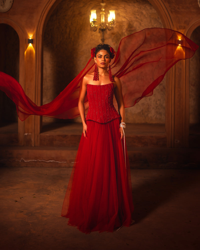 ISHQe campaign: red corset gown with a sheer red veil flying out behind