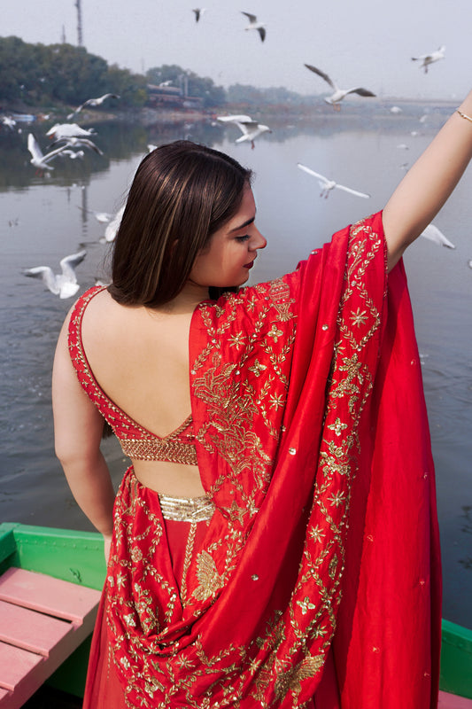 Rose Kawatra in Modo Caldo red fit-and-flare lehenga set with hand-embroidered zardosi blouse and tulle dupatta ideal for weddings and special occasions