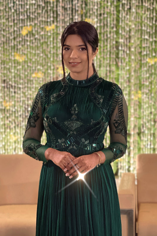 Mahi Bakshi in custom Modo Caldo dark green fit-and-flare gown with hand embroidery full sleeves and zero neck for weddings and cocktails