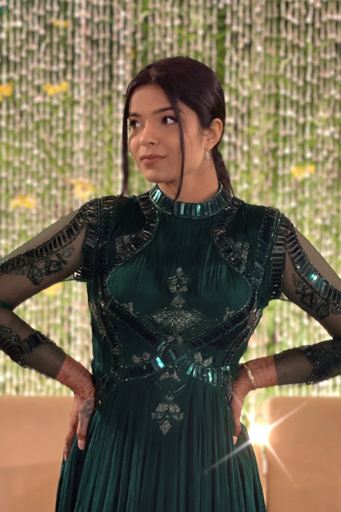 Mahi Bakshi in custom Modo Caldo dark green fit-and-flare gown with hand embroidery full sleeves and zero neck for weddings and cocktails
