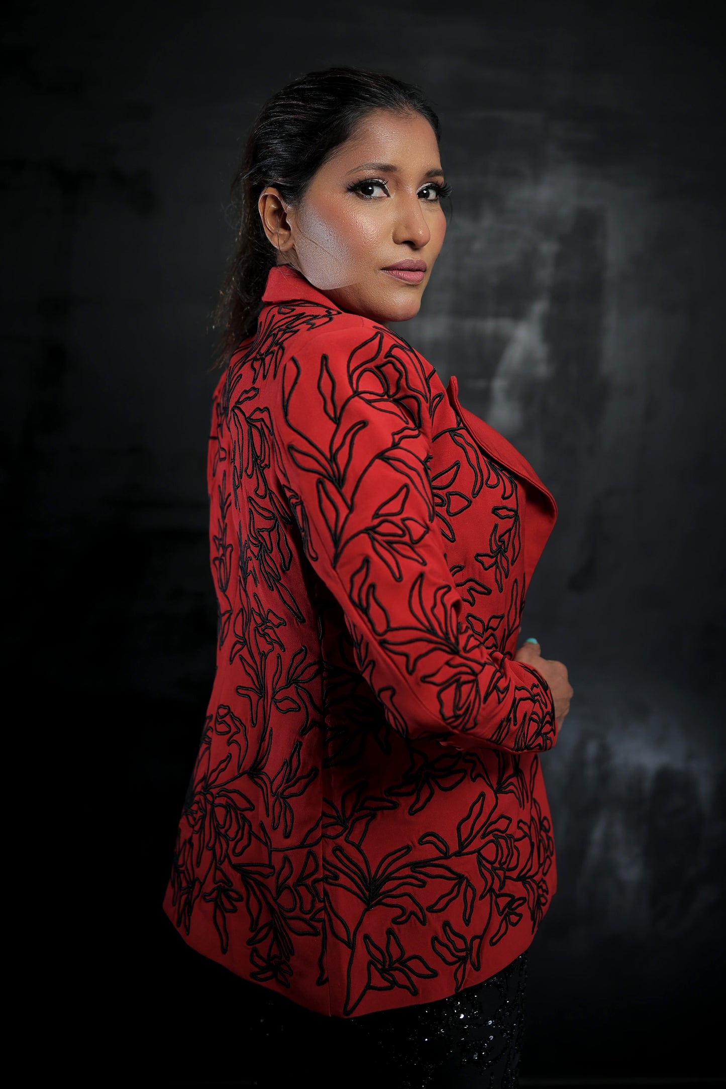 Likhitha Basepogu wearing Modo Caldo red textured blazer with hand-corded embroidery and black embellished boot-cut pants for Mrs Universe