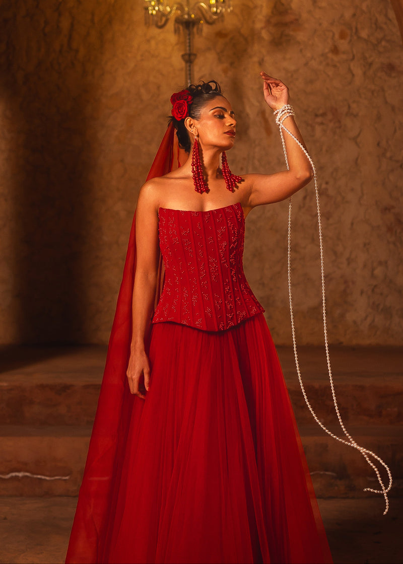 ISHQe campaign: red beaded corset top and red skirt with a long veil and pearl ropes