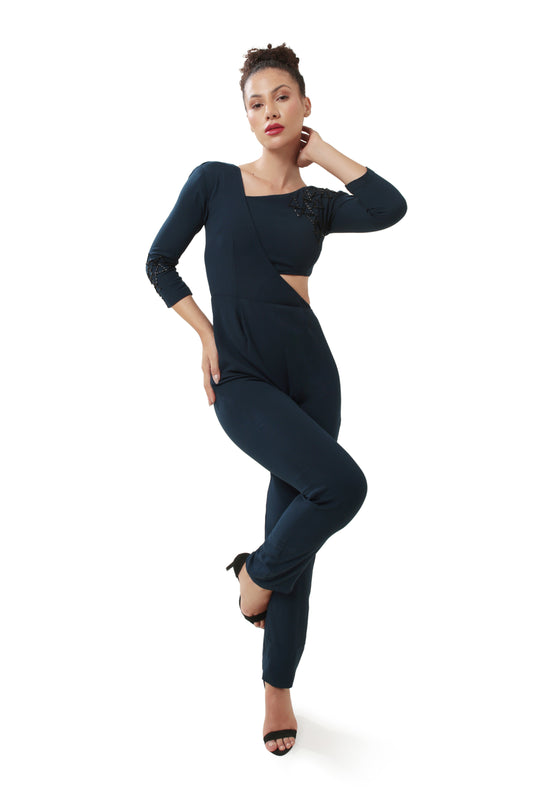 Modo Caldo’s navy blue embellished jumpsuit is tailored from premium moss crepe (100% viscose) with a comfortable shantoon lining. This fitted design features striking asymmetric cutouts and textural hand embroidery, enhancing its sleek silhouette. Padded for structure, it includes quarter-length sleeves and an asymmetric neckline, secured with a discreet zipper closure. Perfect for a sophisticated, contemporary look.