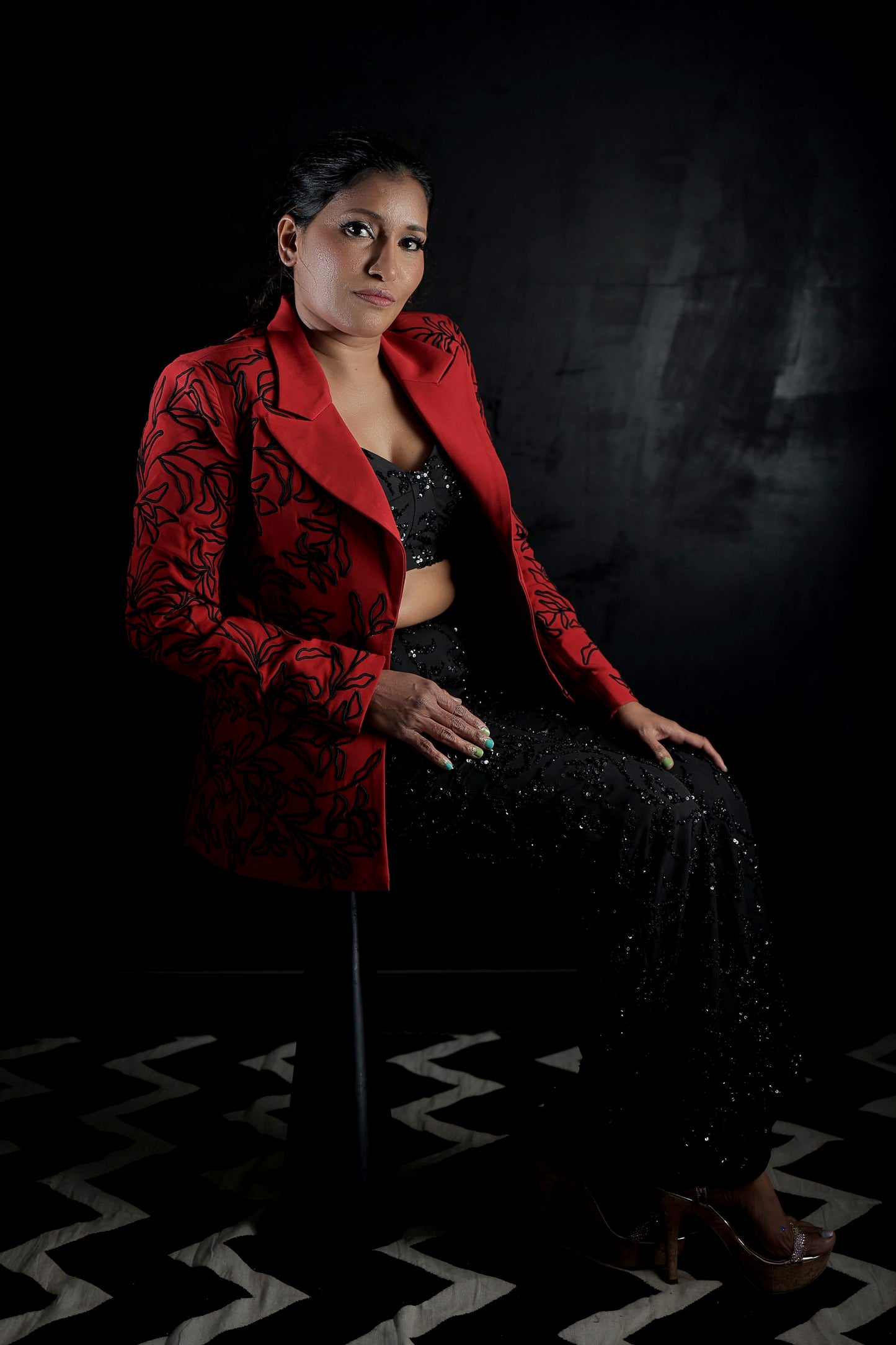 Likhitha Basepogu wearing Modo Caldo red textured blazer with hand-corded embroidery and black embellished boot-cut pants for Mrs Universe