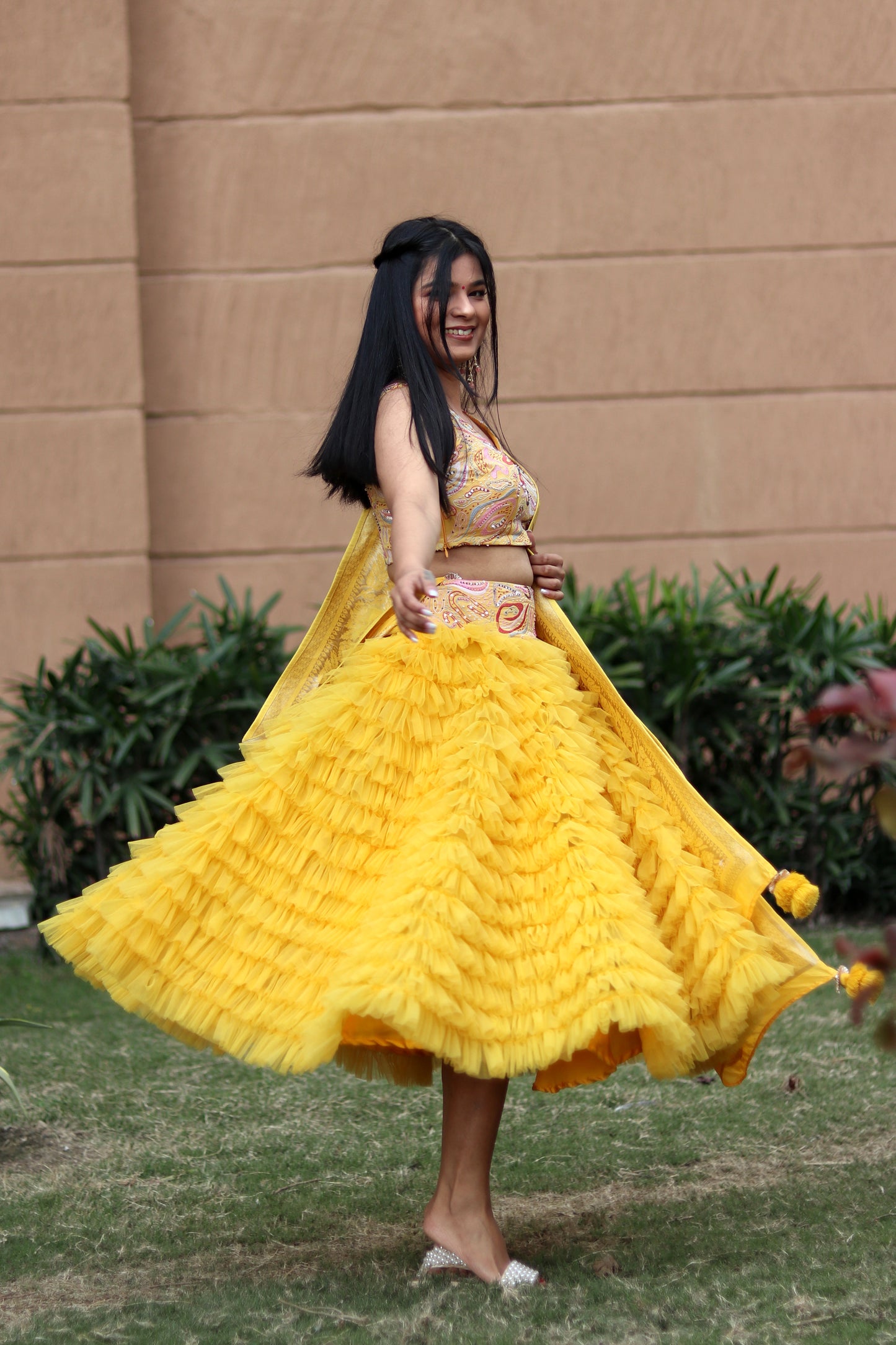 Mahi Bakshi in Modo Caldo yellow ruffled tulle lehenga and hand embellished crop top for festive wear