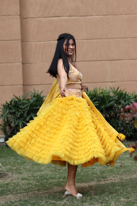 Mahi Bakshi in Modo Caldo yellow ruffled tulle lehenga and hand embellished crop top for festive wear