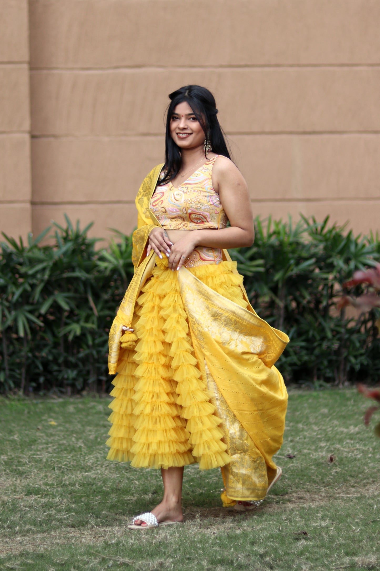Mahi Bakshi in Modo Caldo yellow ruffled tulle lehenga and hand embellished crop top for festive wear