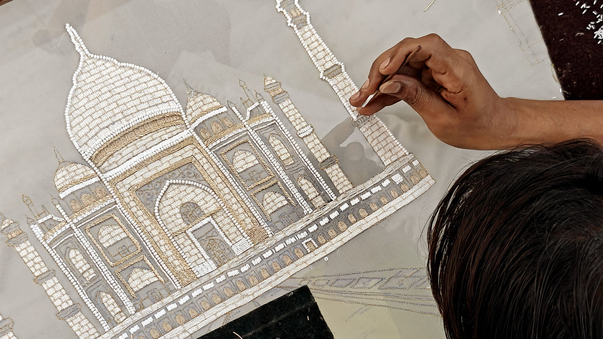 Artisan hand embroidering the Taj Mahal in white thread for Natkhat Zindagi