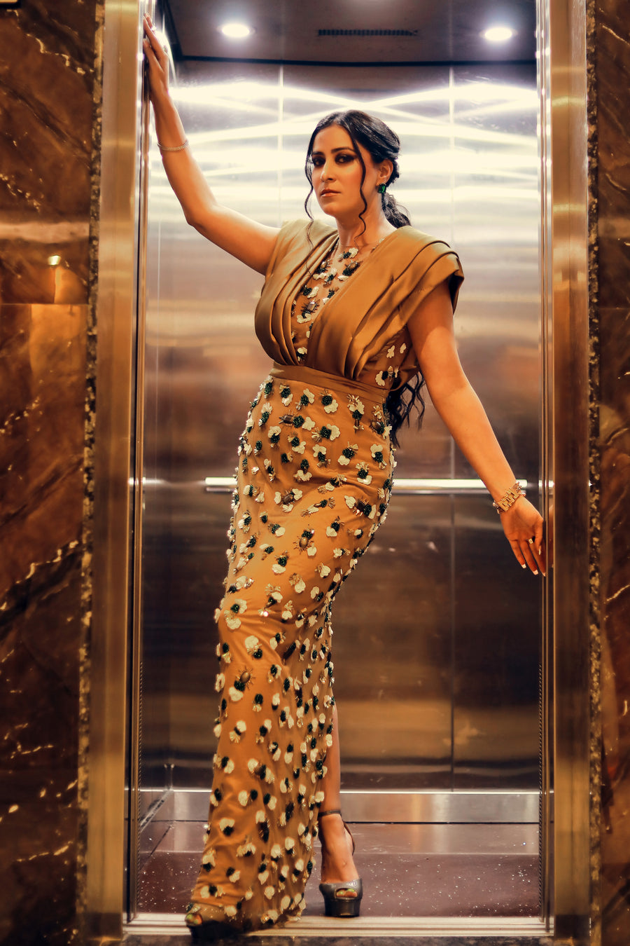 Isha Sharma wearing Modo Caldo copper brown bodycon dress with hand-embroidery and sculpted shoulders for Mrs. International Supermodel