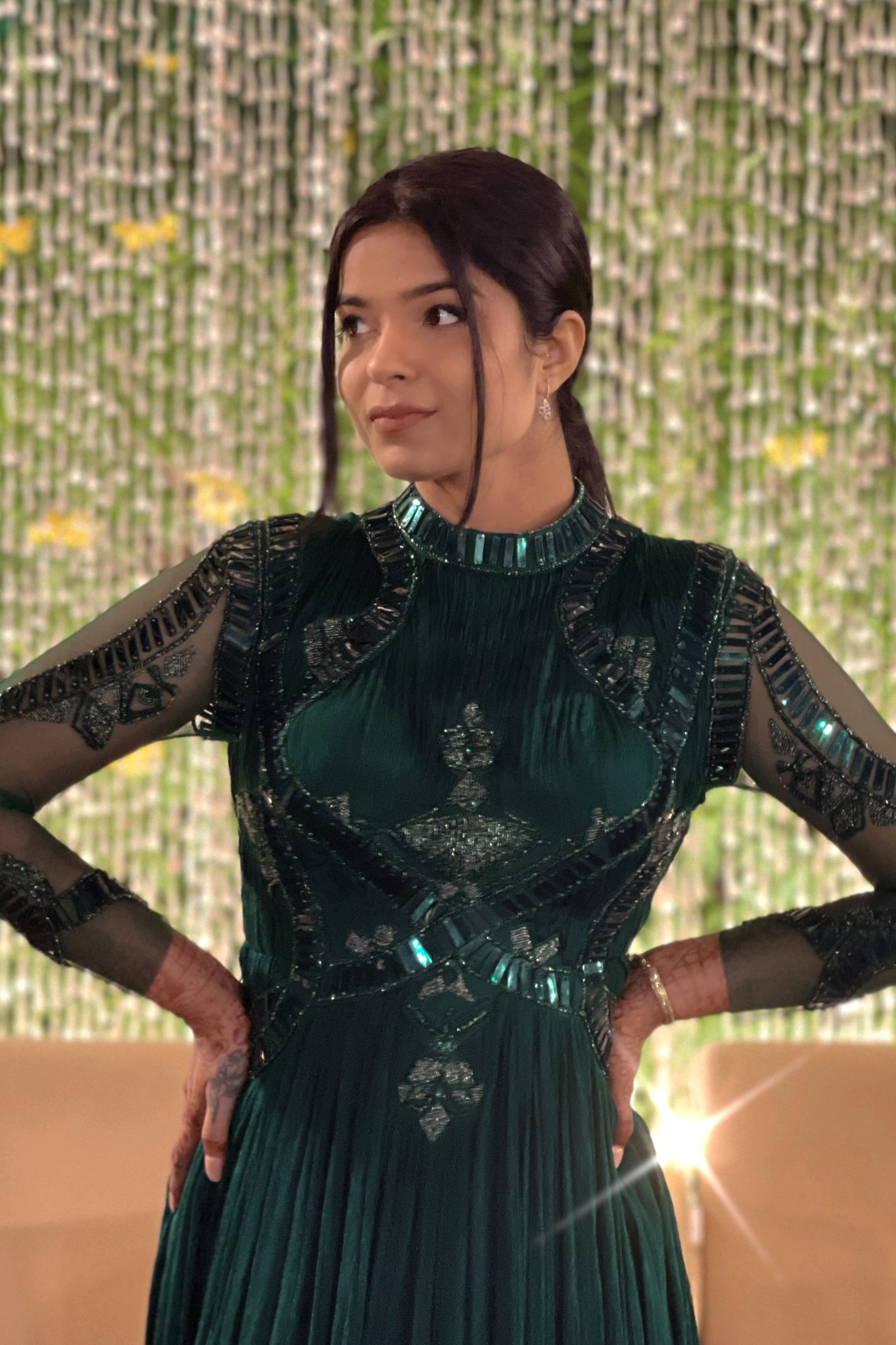 Mahi Bakshi in custom Modo Caldo dark green fit-and-flare gown with hand embroidery full sleeves and zero neck for weddings and cocktails