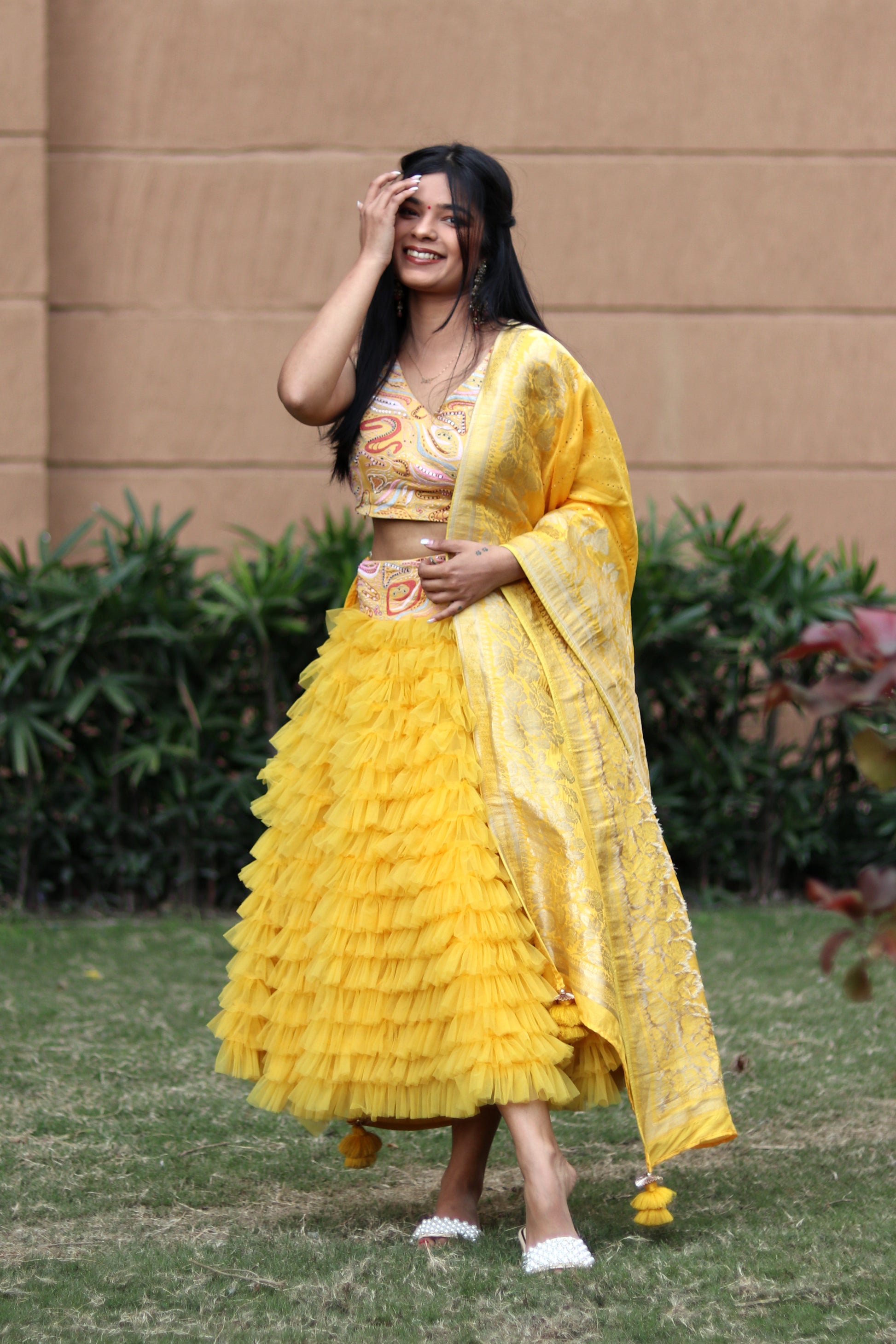 Mahi Bakshi in Modo Caldo yellow ruffled tulle lehenga and hand embellished crop top for festive wear