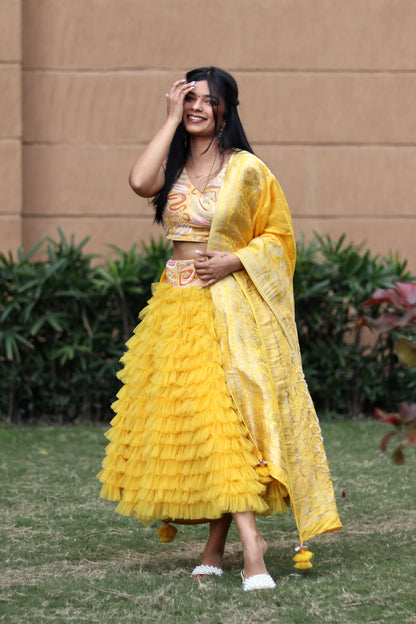 Mahi Bakshi in Modo Caldo yellow ruffled tulle lehenga and hand embellished crop top for festive wear