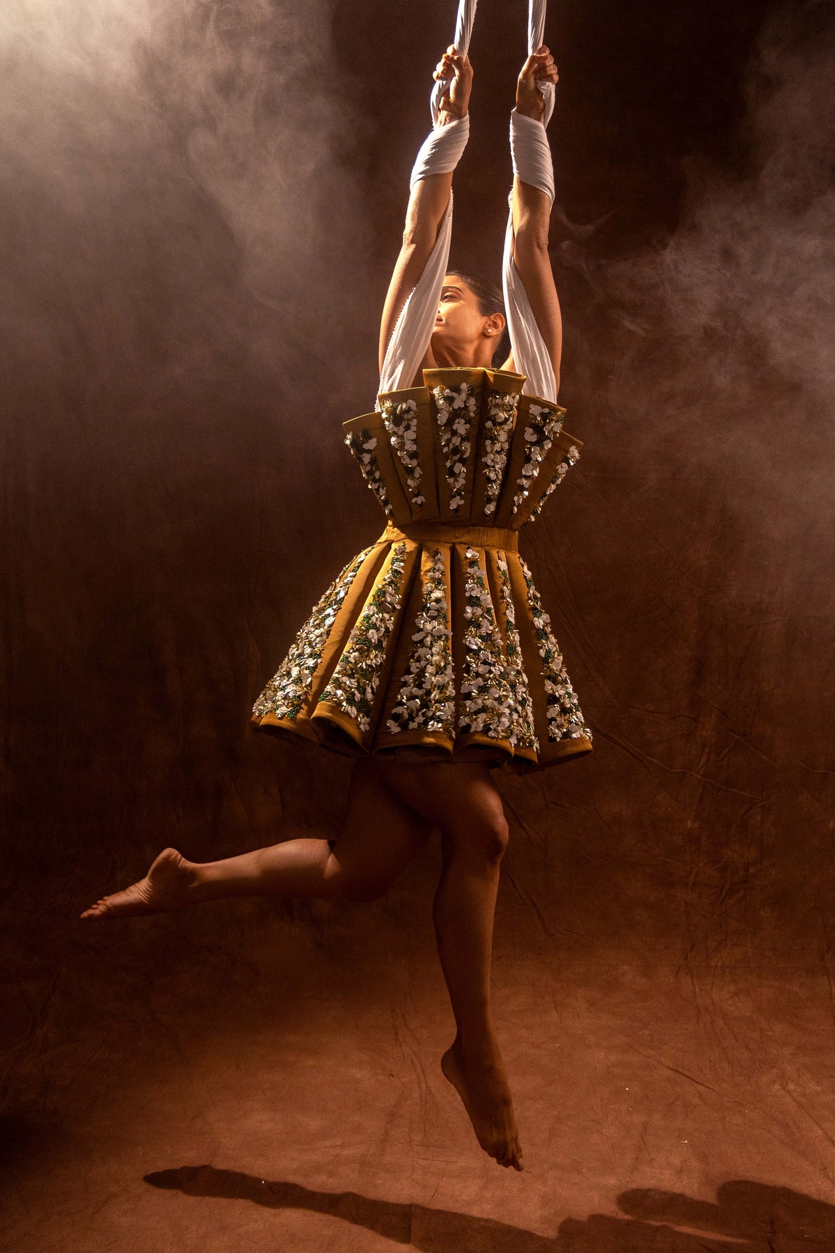 Short dress with a fluted bodice and stiff pleats radiating from the waist