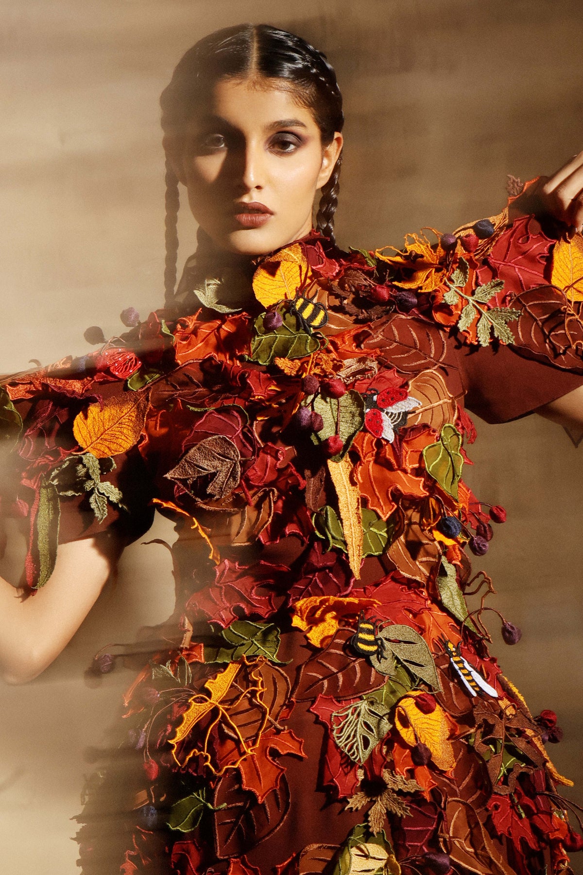 Hundreds of embroidered leaves layered across the bodice and sleeves