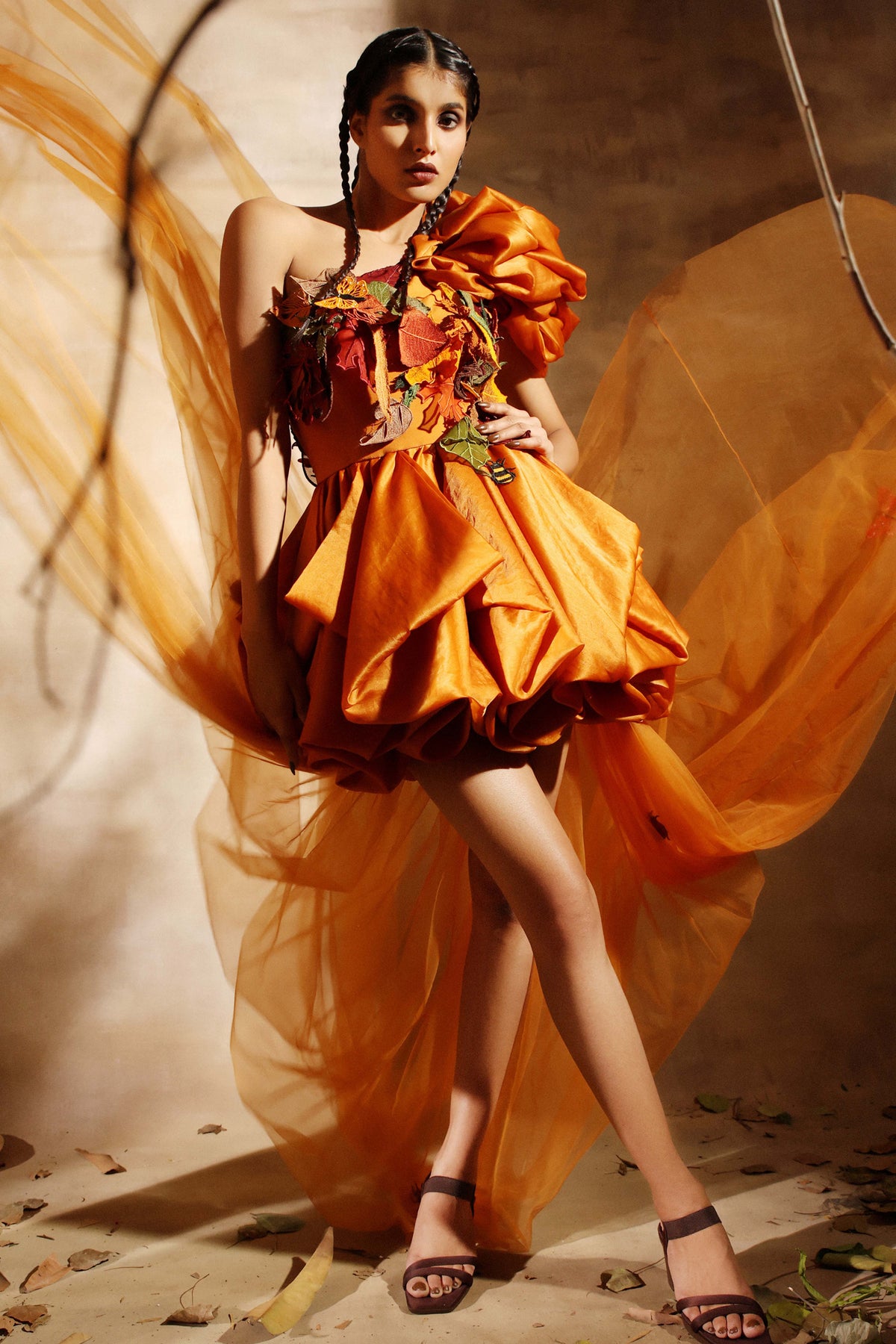 One shoulder mustard dress with a puffed skirt and a long soft trail
