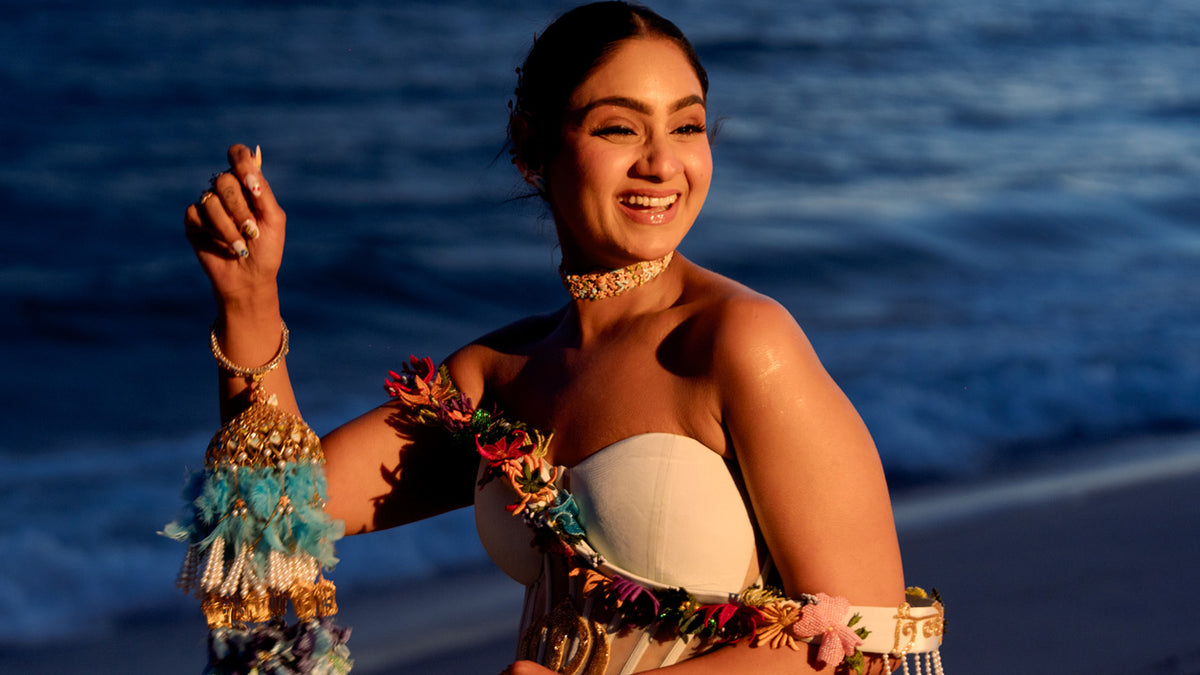 Pavitra Kaur at Cannes waving in Natkhat Zindagi with embroidered tassel sleeves at dusk