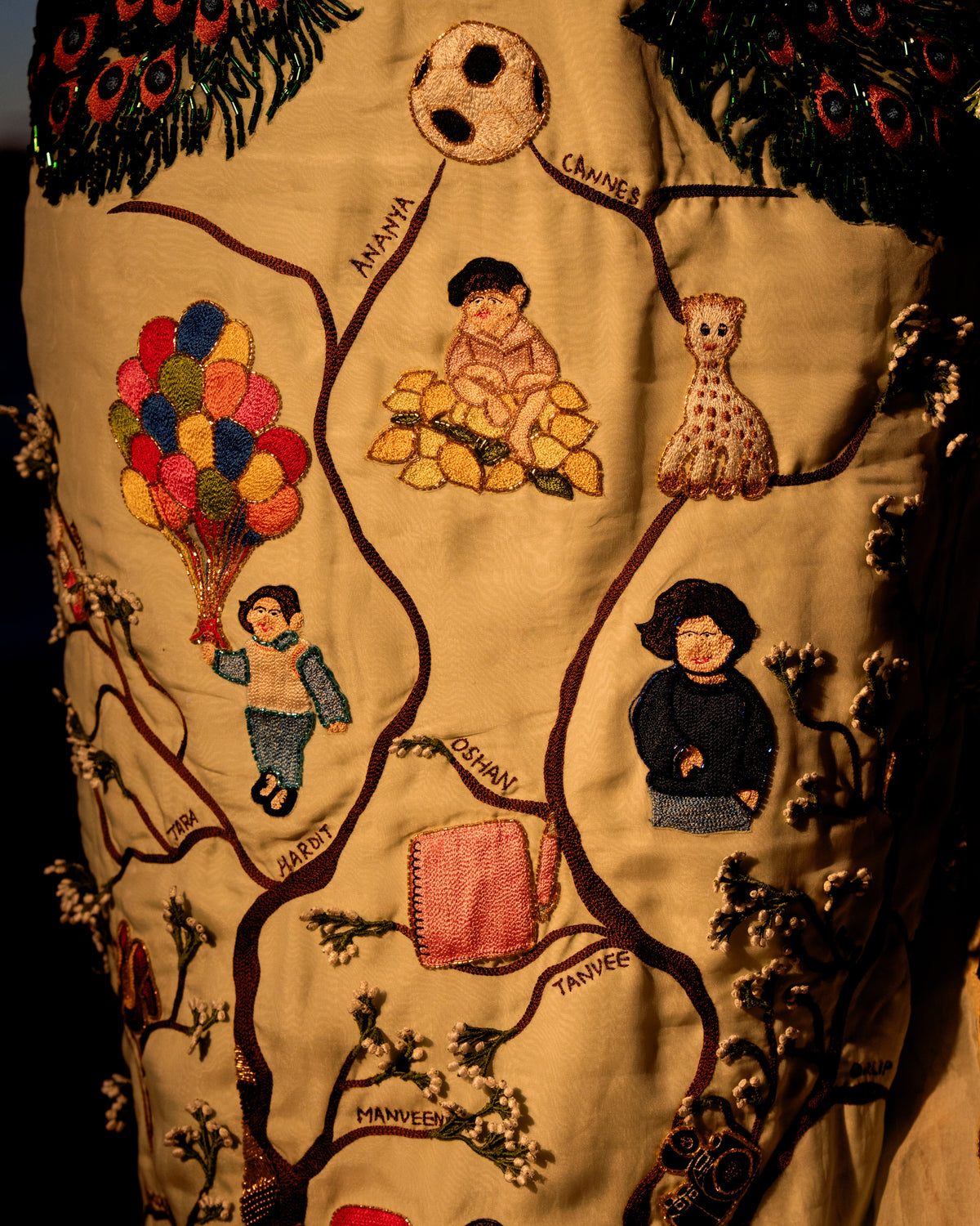 Embroidered family tree with portraits and a hot air balloon on the Natkhat Zindagi gown