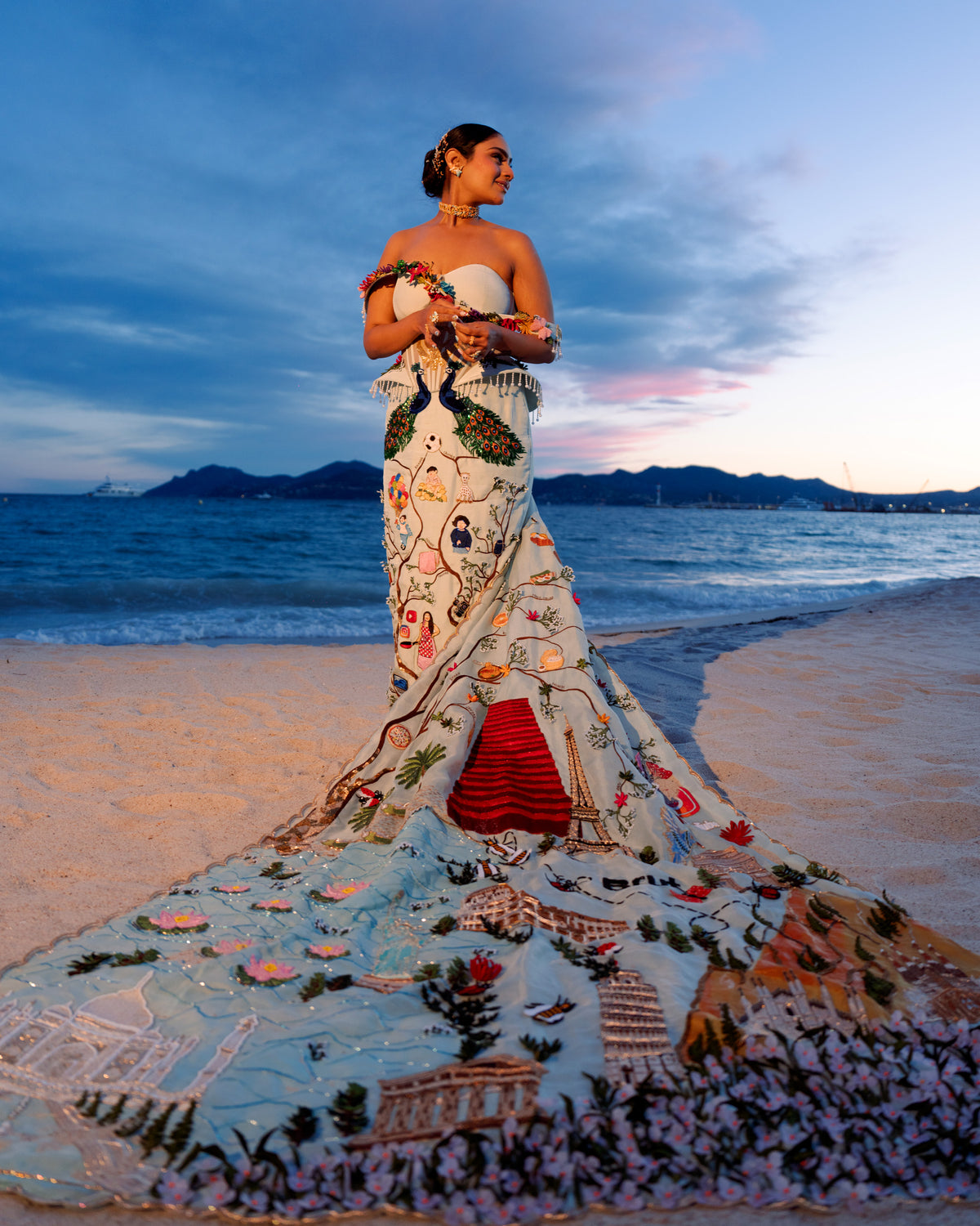 Natkhat Zindagi gown with a long storytelling embroidered train on the beach at Cannes